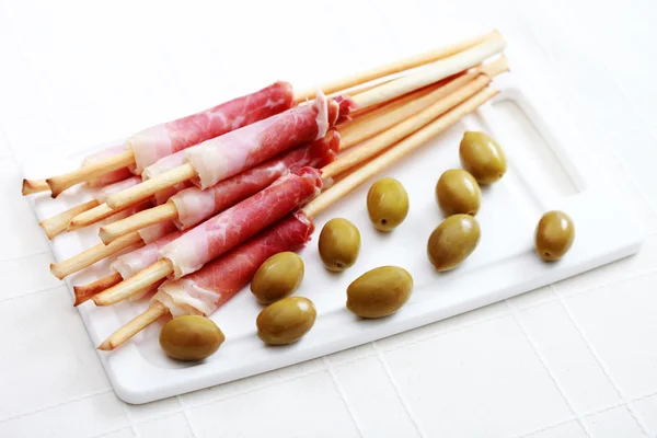 Grissini with ham and olives — Stock Photo, Image