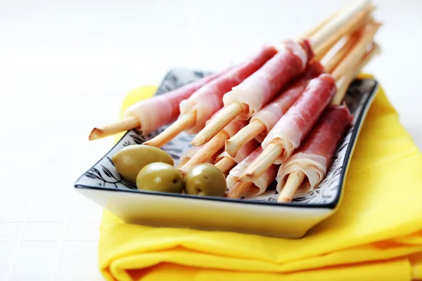 Grissini with ham and olives — Stock Photo, Image