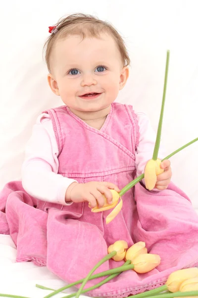 Baby girl with flowers — Stock Fotó