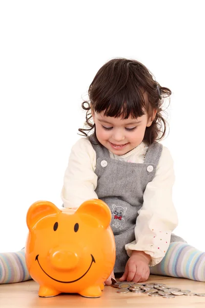 Girl and piggy bank — Stock Photo, Image