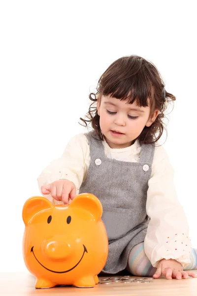 Girl and piggy bank — Stock Photo, Image