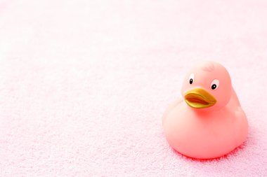 rubber duck on pink towel - body care clipart