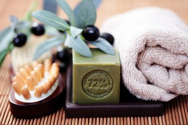 bar of olive oil soap and some spa products clipart