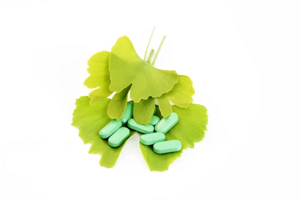 stock image close-ups of pills and ginko leaves - alternative medicine