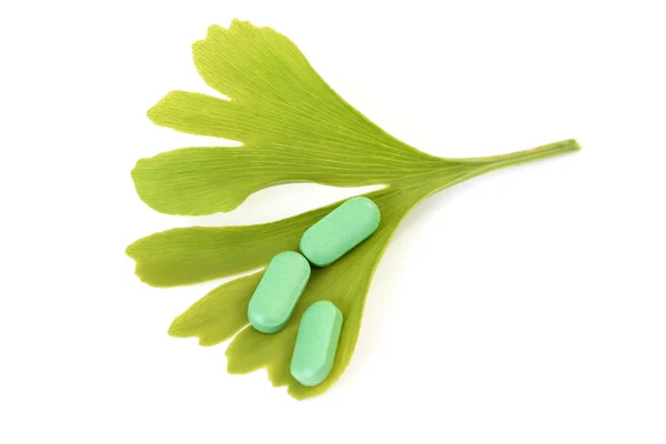 stock image close-ups of pills and ginko leaves - alternative medicine