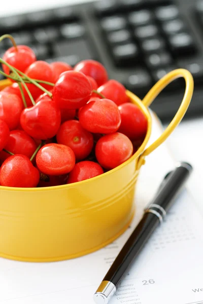 stock image healthy snack in the office - bowl of cherries