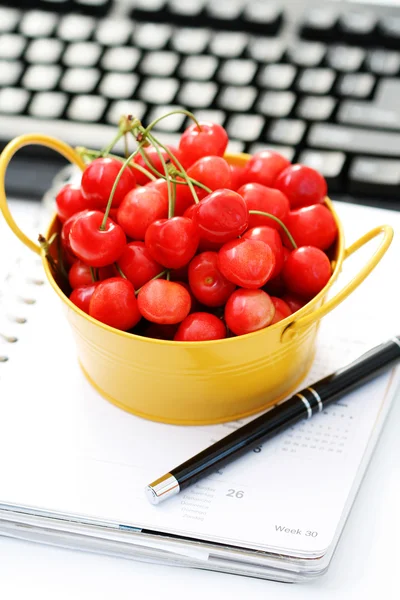 stock image healthy snack in the office - bowl of cherries