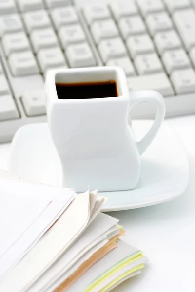 stock image cup of coffee at work - lots to do