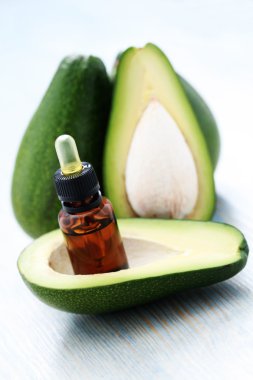 bottle of avocado essential oil with fresh fruit - beauty treatment clipart