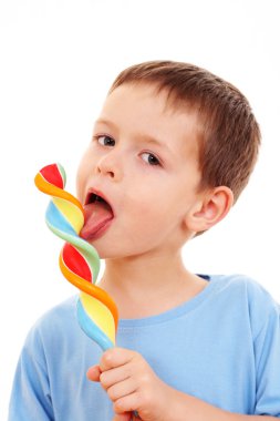6-7 years old boy with lollipop on white - kids clipart