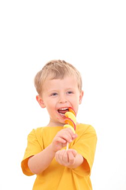 4-5 years old boy with lollipop on white - kids clipart