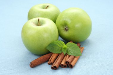 green apples with cinnamon sticks and mint clipart