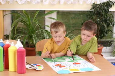 Two preschoolers and colorful painting - education clipart