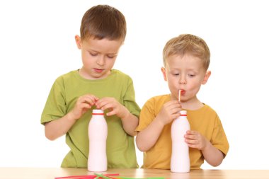 five and three years old boys drinking milk isolated on white clipart