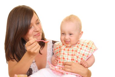 mother and 8 months baby girl with baby food isolated on white clipart