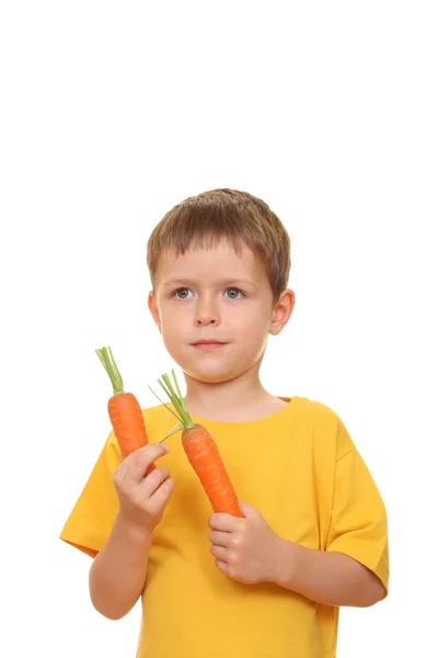 吃新鲜胡萝卜孤立在白色的五岁男孩 — 图库照片