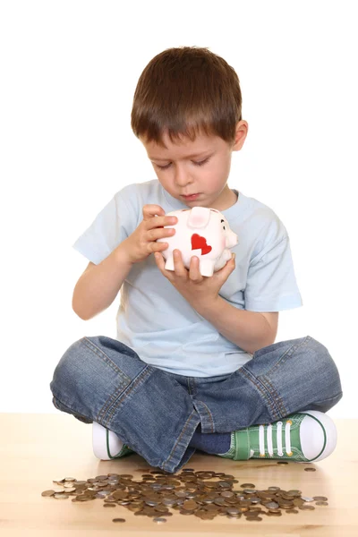 stock image five years boy with piggy bank and money isolated on white