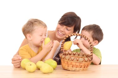 mother and two boys with fresh pears isolated on white clipart