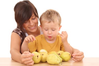 mother and 3-4 years old boy with fresh pears isolated on white clipart