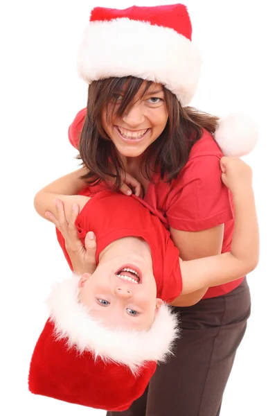母はクリスマスで楽しんでいる歳の息子に分離された白の帽子 — ストック写真