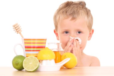 3-4 years old boy with cold and flu remedy on white /focus on kid/ clipart