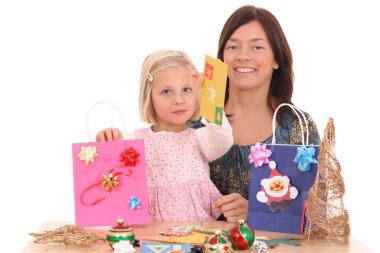 mother and 5-6 years old girl making Christmas decoration /all decorations are made by mother and child/ clipart