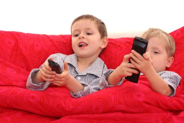 two brothers watching TV in bed clipart