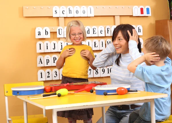 Lehrerin Und Zwei Vorschulkinder Spielen Mit Instrumenten — Stockfoto