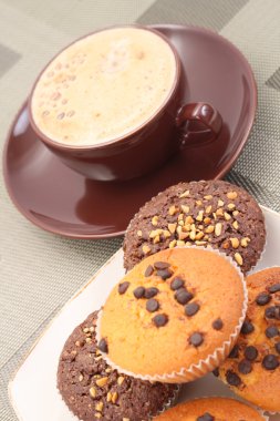 plate of chocolate muffins and cup of coffee close-ups clipart