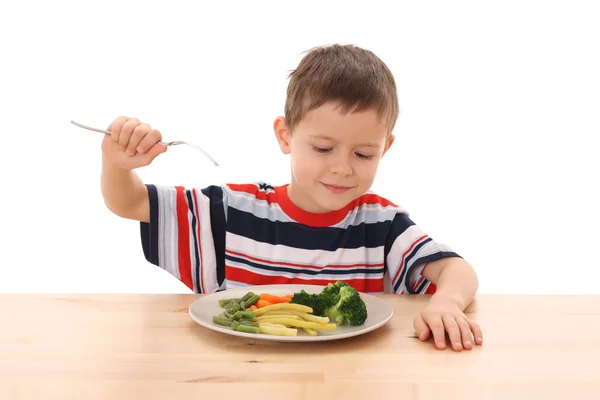Хлопчик і варені овочі — стокове фото