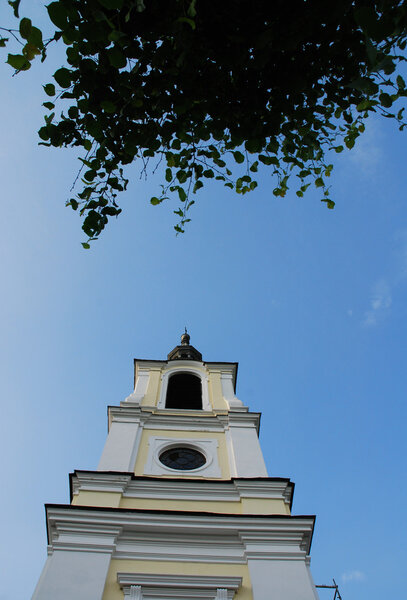 Church tower with sun and blue sky