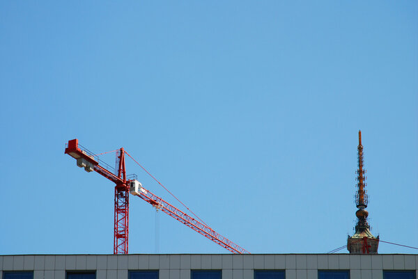 Steel crane at building site on the blue sky