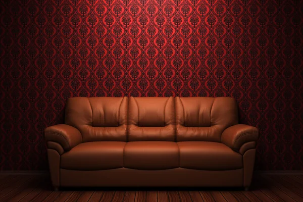 Sofá de cuero marrón frente a la pared roja — Foto de Stock