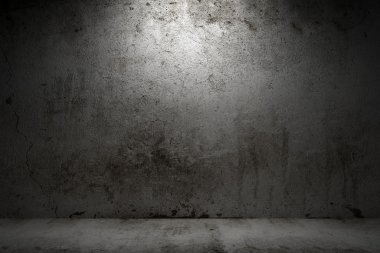 Empty room with grunge concrete wall and cement floor