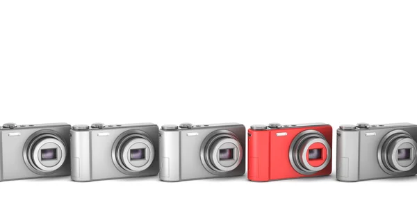 Stock image Red point and shoot photo camera among gray similar isolated on white backg