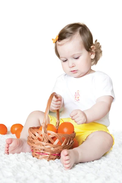 Little girl with tangerines — Stock Photo, Image