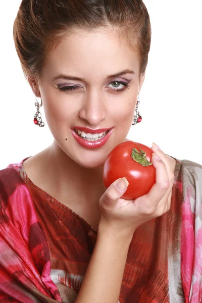 The young woman with a tomato in hands — Stock Photo, Image