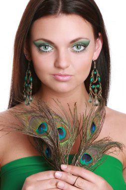 Portrait of a beautiful young woman with peacock feather clipart