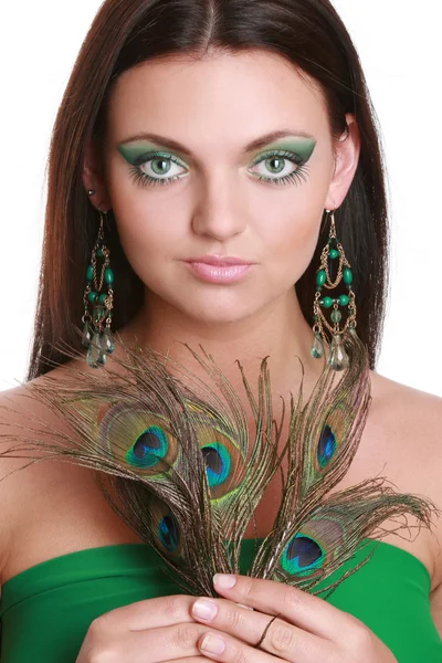 Portrait of a beautiful young woman with peacock feather — Stock Photo, Image