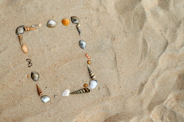 Shells on sand frame — Zdjęcie stockowe