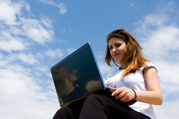 Laptop ve mavi gökyüzü ile kadın — Stok fotoğraf