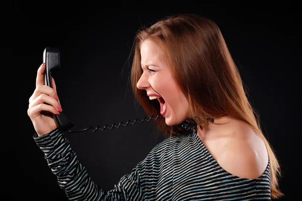 Kobieta z odbiornikiem telefonu — Zdjęcie stockowe
