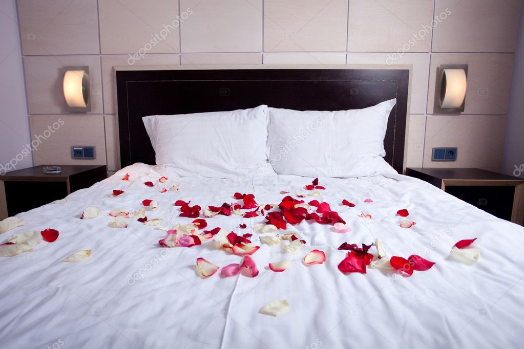 rose petals leading to the bed