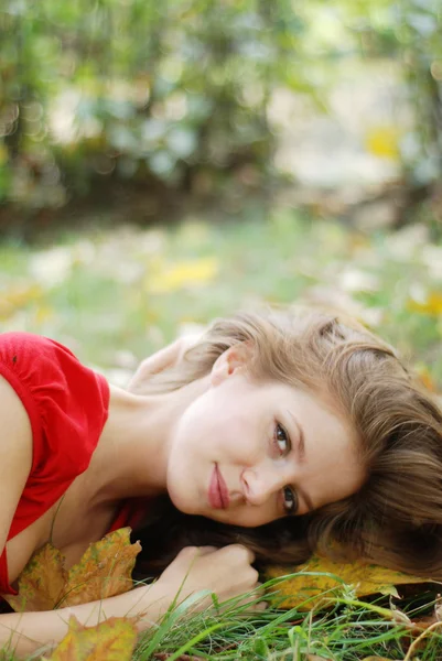 Young woman and leaves — Stock Photo, Image