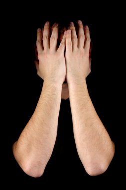 Man hiding his face on black background clipart