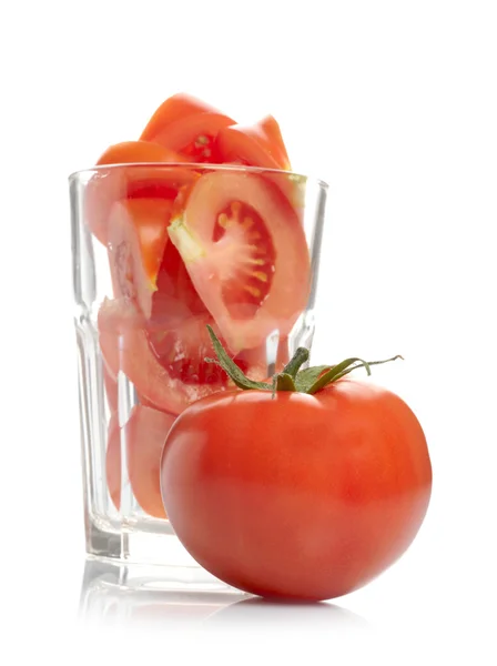 Tomato and tomato slices in glass — Stock Photo, Image