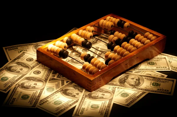 Old abacus on dollars and euro background — Stock Photo, Image