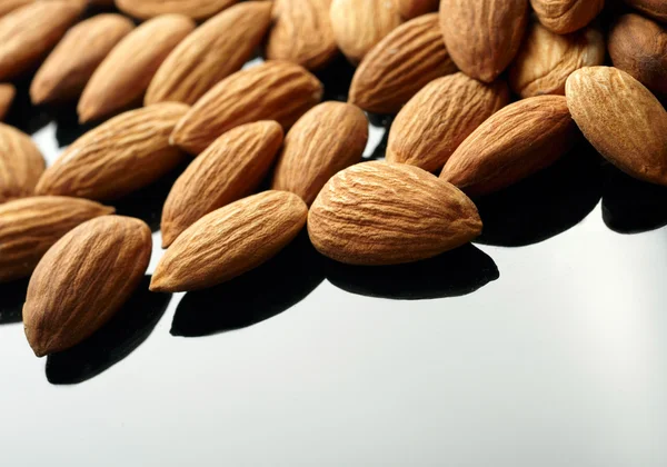 Almonds on black backgrond — Stock Photo, Image