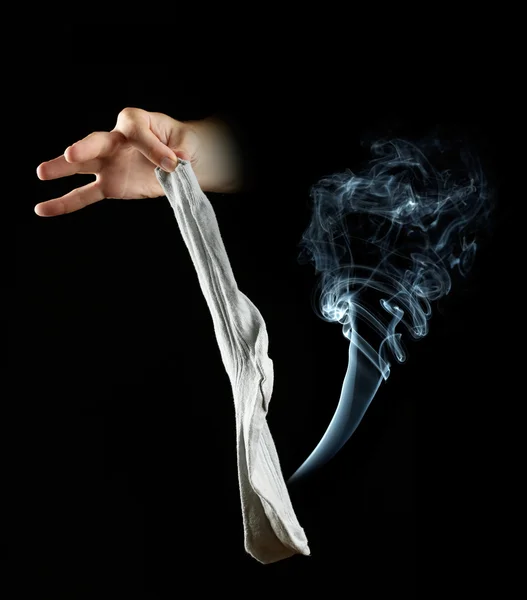 Hand holding stinky sock on black background — Stock Photo, Image