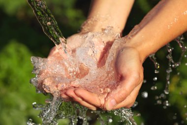 Woman's hands with water splash clipart